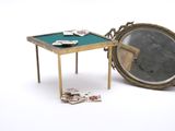 a small table with cards and a mirror on it