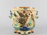 a vase with a bird on it sitting on a stand