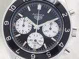 a close up of a watch with a black face
