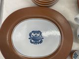 many plates and cups sitting on a tray on a table