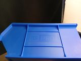 a blue plastic container with a lid on a wooden table