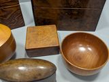 several wooden bowls and a wooden box on a table