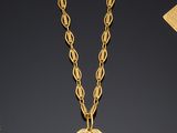 a gold necklace with a small square pendant on a chain