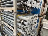 a large pile of steel pipes stacked on top of each other