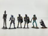 a group of figurines of star wars characters on a white surface