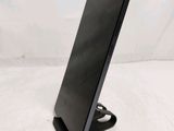 a close up of a tablet computer on a stand on a white surface