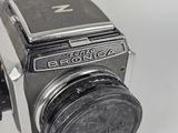 a close up of an old camera with a lens on it
