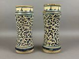 pair of blue and white vases sitting on top of a table