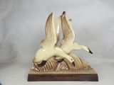 two birds that are sitting on top of a table