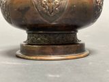 a metal bowl with a decorative design on it