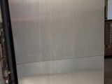 an image of a stainless steel refrigerator in a garage