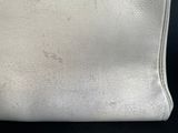 a close up of a white purse on a black surface