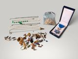 a box of jewelry sitting on a table next to a bag