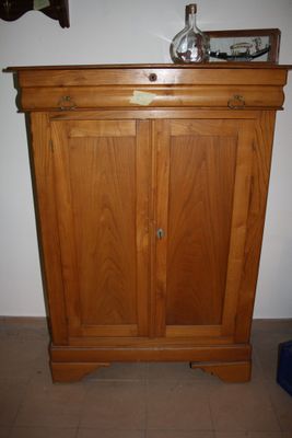 a wooden cabinet with a mirror on top of it