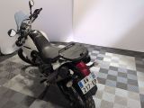a motorcycle that is parked in a room with a checkered floor