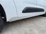 a close up of a white truck with a flat tire