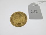 a gold sovereign coin with a price tag on it