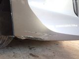 a close up of a car ' s bumper with a denting on it