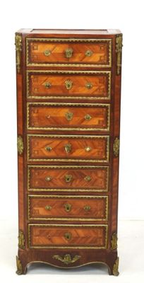 une vieille commode en bois ornée de garnitures dorées