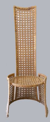 une chaise en osier avec une assise en bois sur fond gris