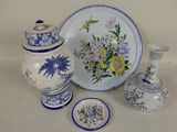 a lot of blue and white vases and plates on the table