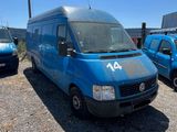 the blue van is parked in a lot next to other cars