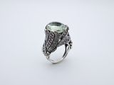 a green tourmaline and diamond ring set in silver