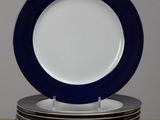 six blue and white plates stacked on top of each other