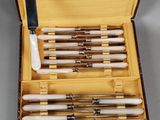 a box with eight different types of pens in it
