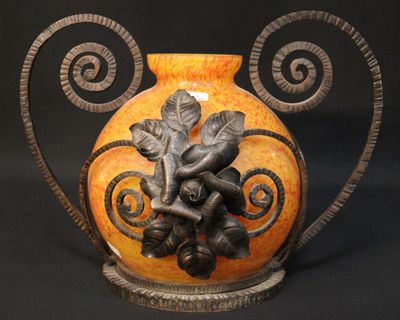 a vase with a design on it sitting on a table