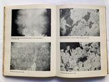 an open book with black and white photos of a city