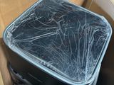 a black suitcase in a cardboard box with a broken lid