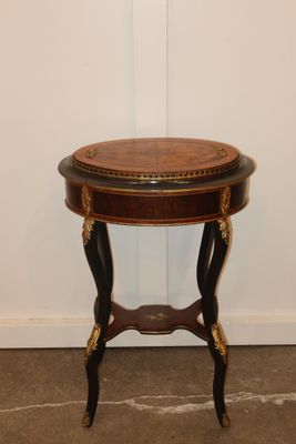 an image of a small table with a wooden top on a floor