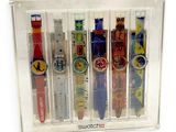 five different colored watches in a clear display case