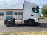 a white semi truck parked in front of a building