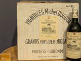 a bottle of wine sitting next to a box of cheese
