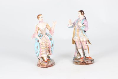pair of porcelain figurines of a woman and a man