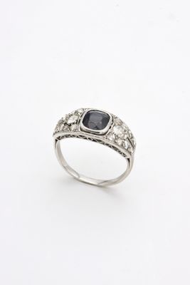 a close up of a ring with a black stone on it
