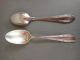 two spoons sitting next to each other on a table
