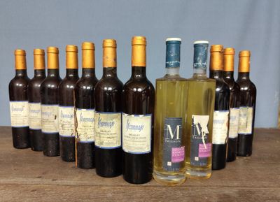 bottles of wine are lined up on a wooden table