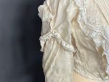 an image of a woman ' s white blouse with lace on it