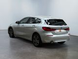 the rear end of a silver bmw car in a white room
