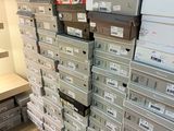 many boxes stacked on top of each other in a room