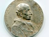an old silver coin with a portrait of a man on it