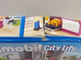 two boxes of playmobil city life toys on the table