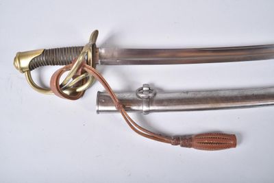 a close up of a sword on a white surface