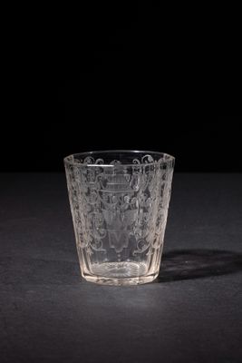 a close up of a glass on a table with a black background