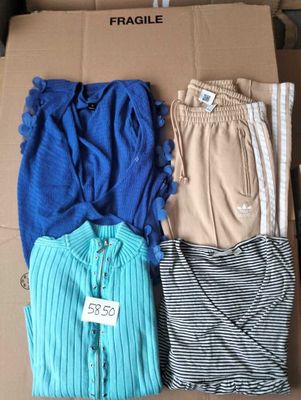three pairs of pants and a shirt in a box