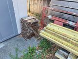 a wooden bench next to a pile of firewood