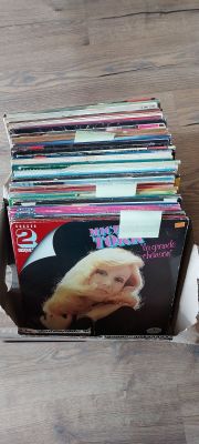 a lot of magazines in a box on the floor